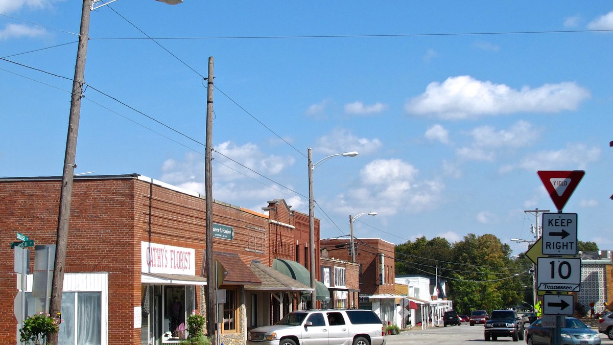 Brick storefronts along the courthouse square in Lafayette, Tennessee, under a blue sky